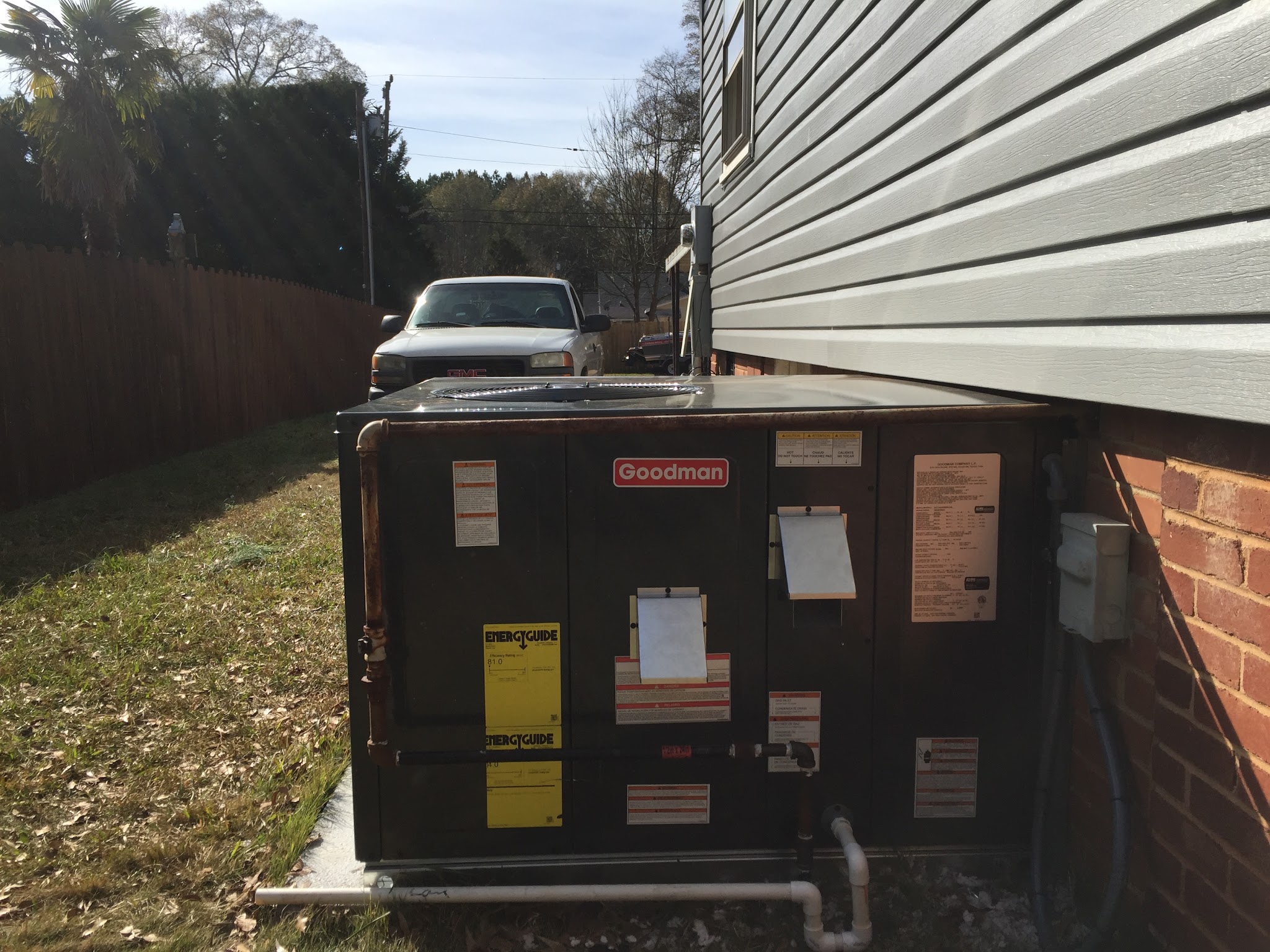 Ground-level unit beside a brick-trimmed house